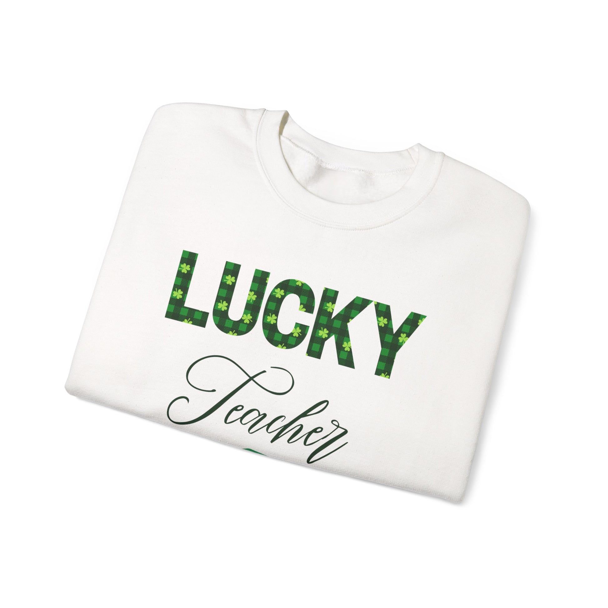 Folded Lucky Teacher sweatshirt with green clover letters and book icon, St. Patrick’s Day design.