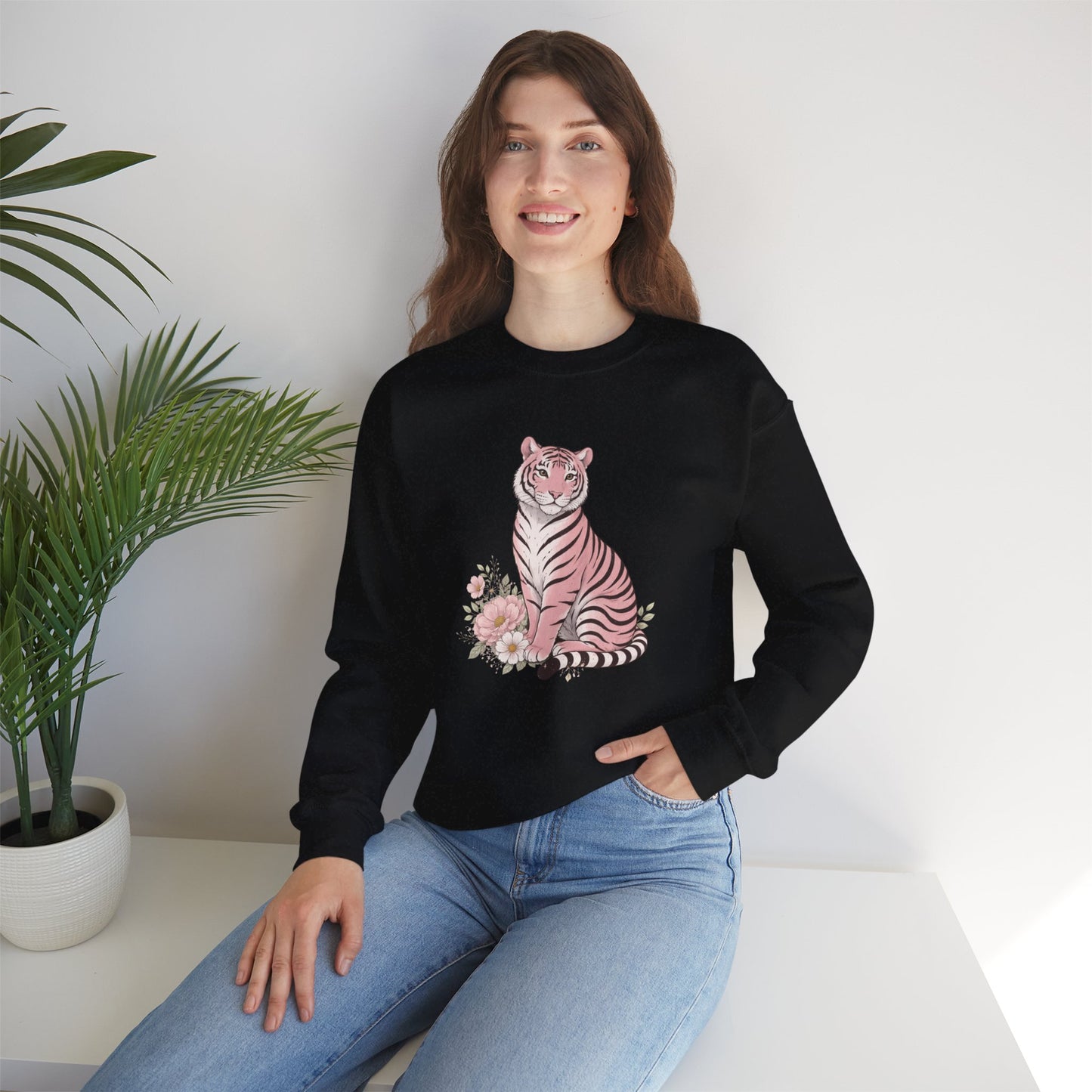 A cozy unisex sweatshirt featuring a pink tiger sitting among pastel flowers