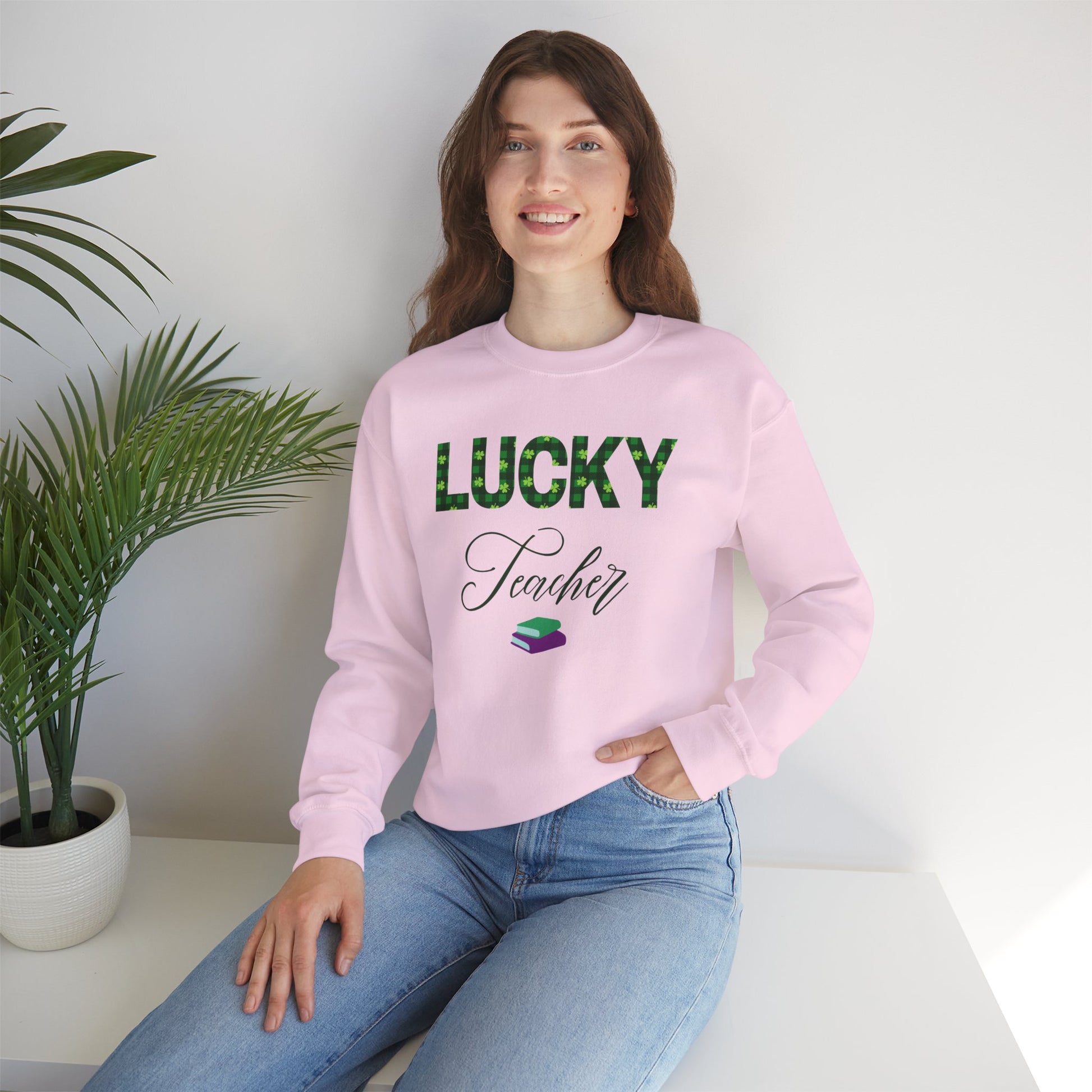 Model wearing Lucky Teacher sweatshirt with green clover lettering and book icon.