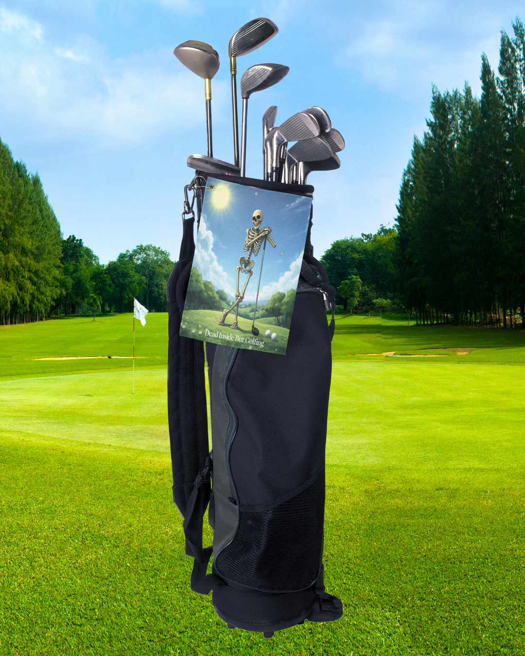 Skeleton golf towel hanging from a black golf bag on a sunny golf course, featuring the phrase ‘Dead Inside But Golfing’ and a humorous skeleton golfer design.