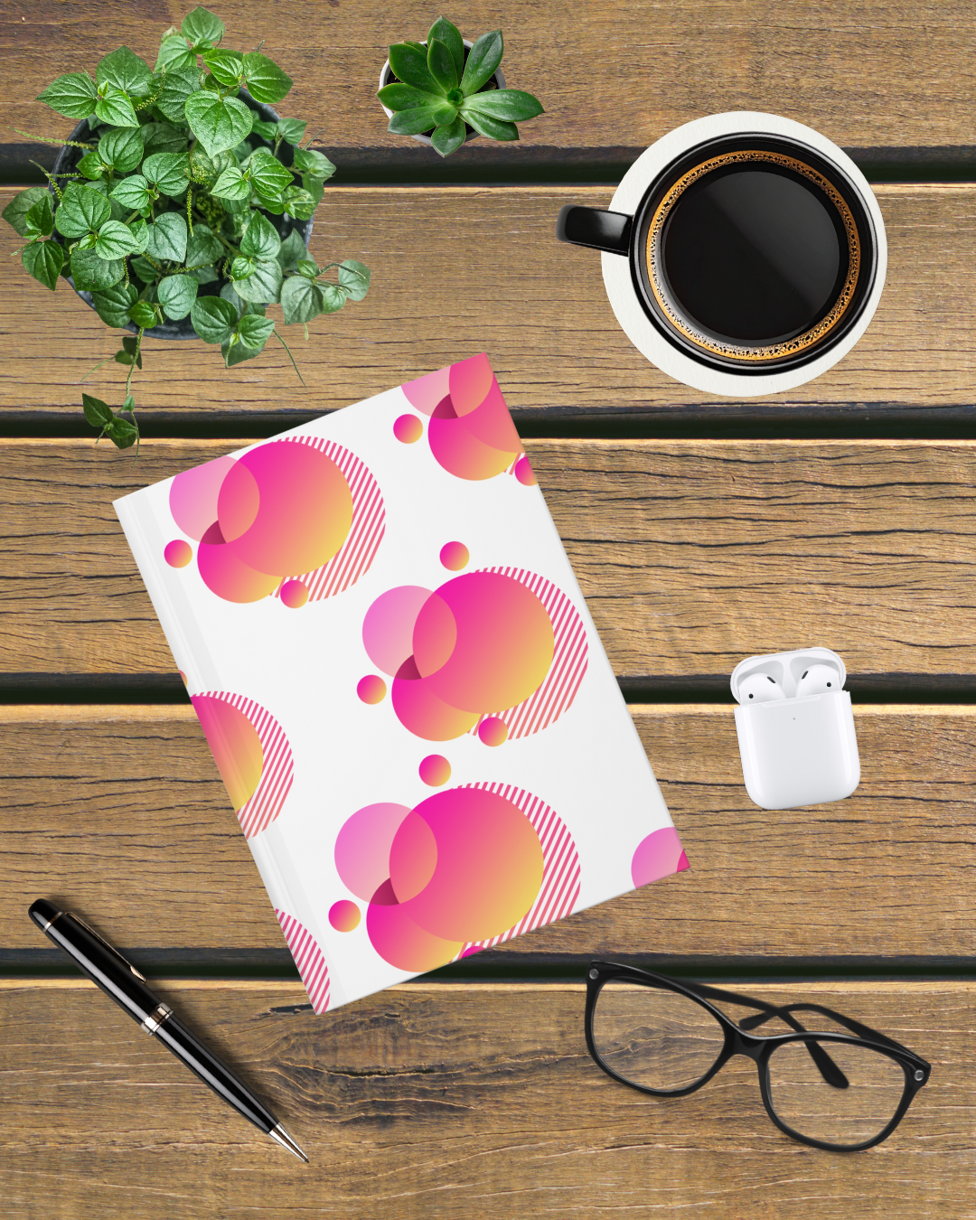 Colorful geometric hardcover journal with abstract pink and orange design, styled as a modern aesthetic notebook for journaling and everyday writing.