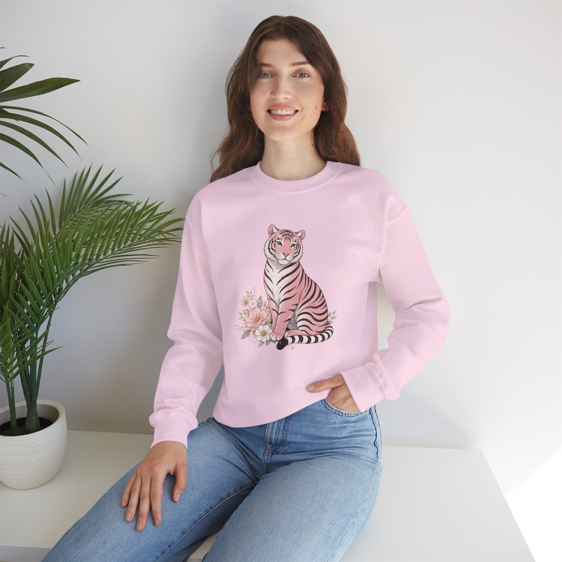  A cozy unisex sweatshirt featuring a pink tiger sitting among pastel flowers