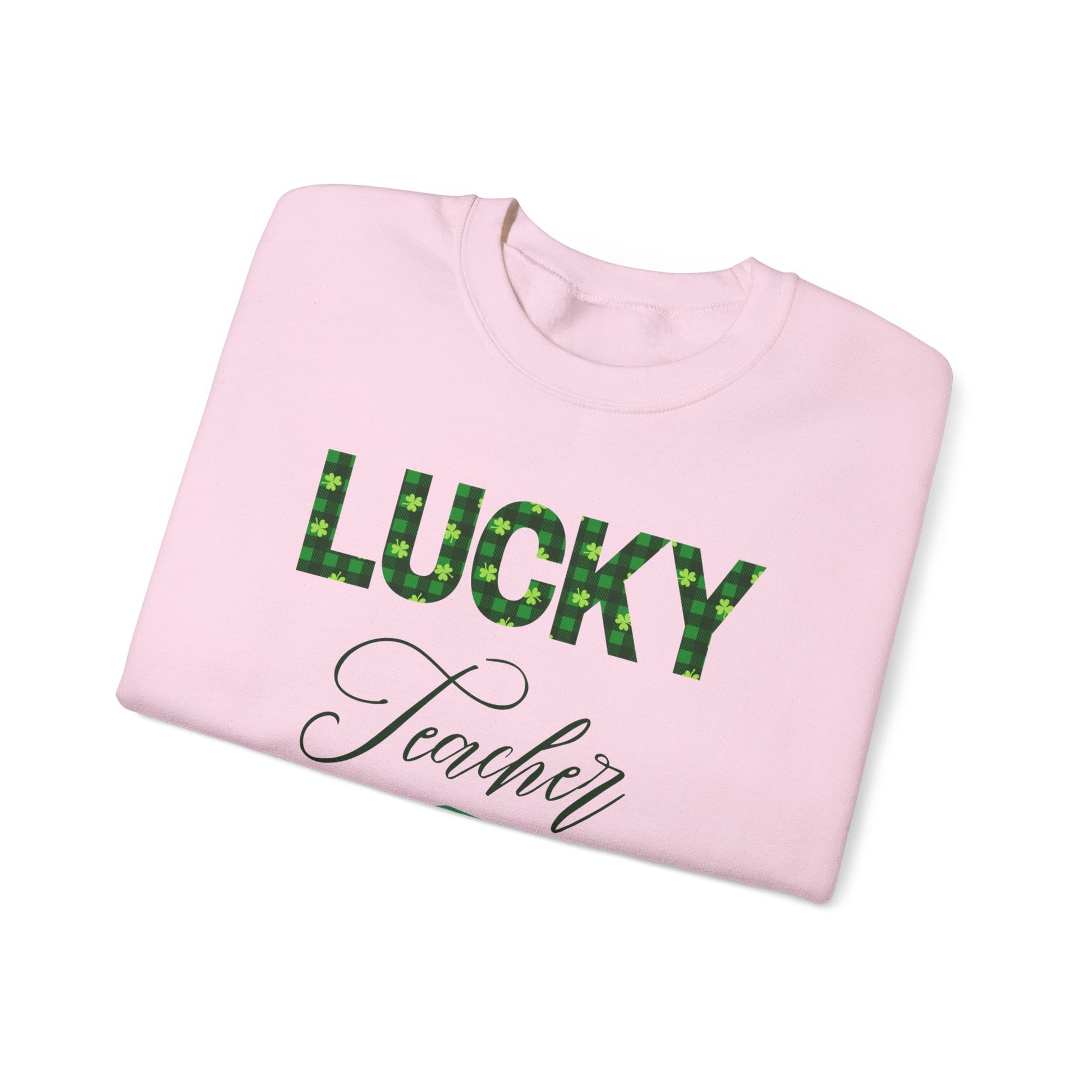 Folded Lucky Teacher sweatshirt with green clover lettering and book icon.